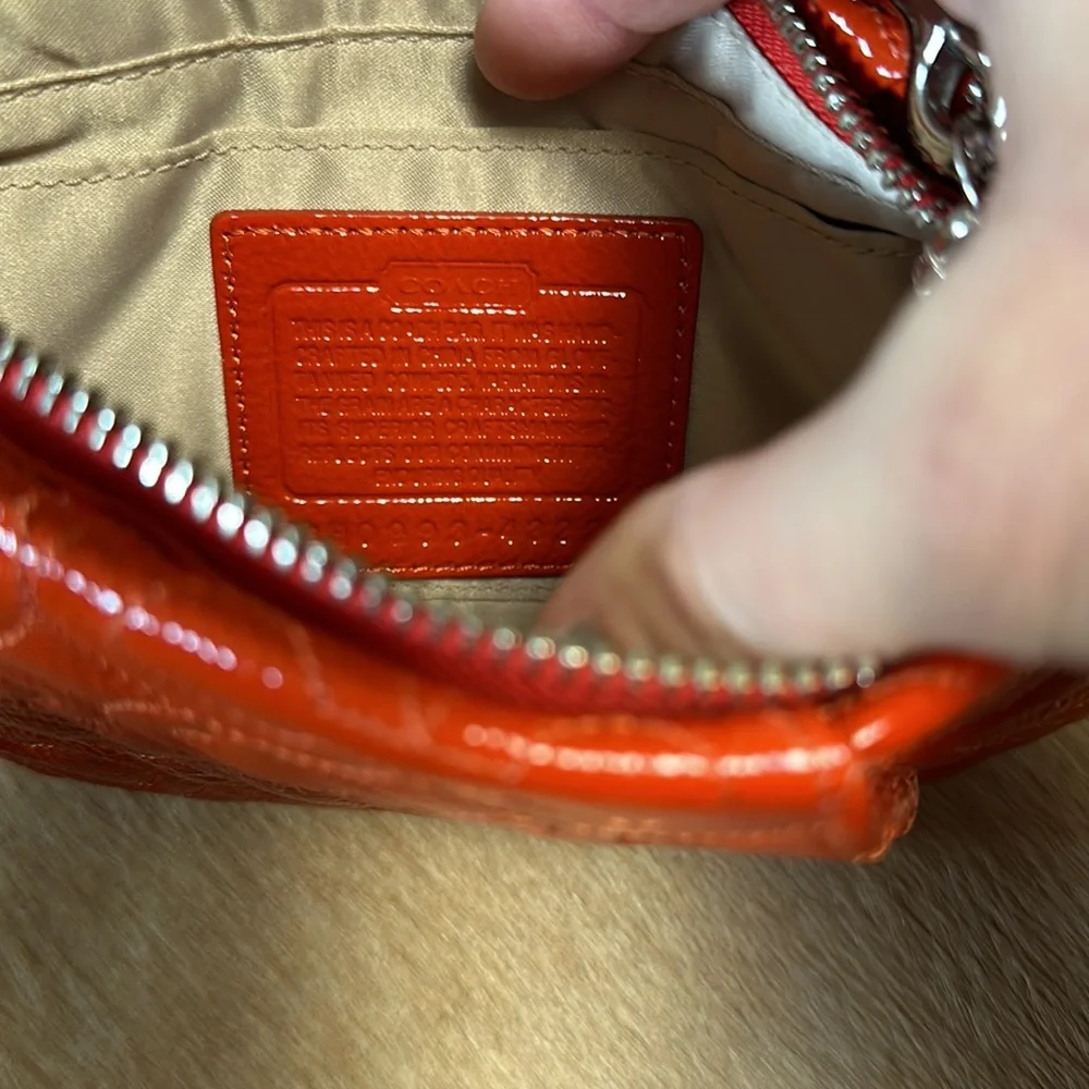 Coach - orange patent wristlet